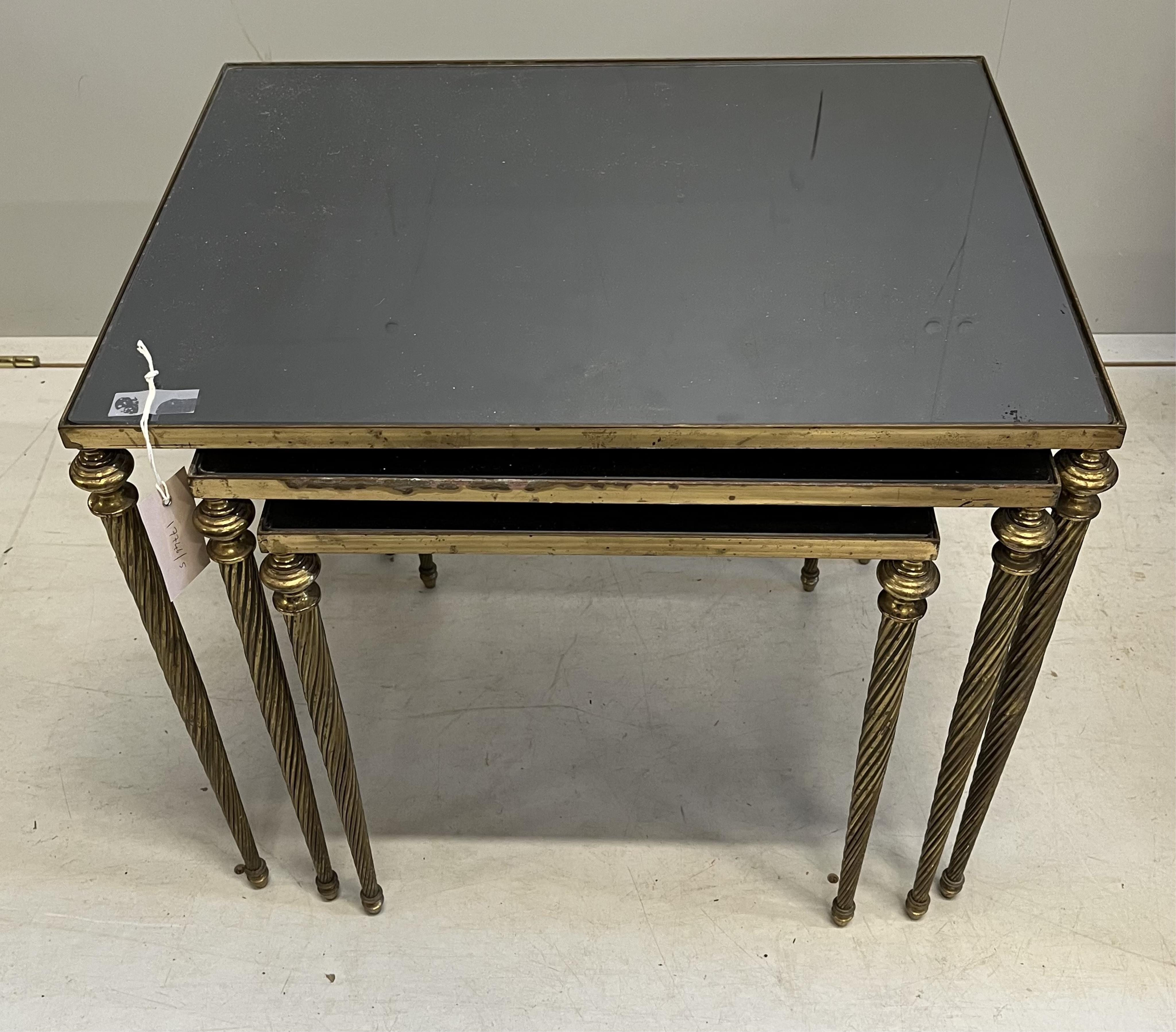 A nest of three brass and smoked glass tables, width 54cm, depth 40cm, height 45cm